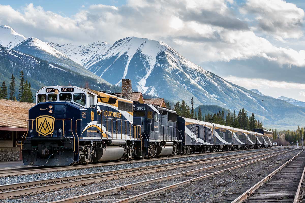 A luxury train travelling through the snow-capped Canadian Rocky Mountains.